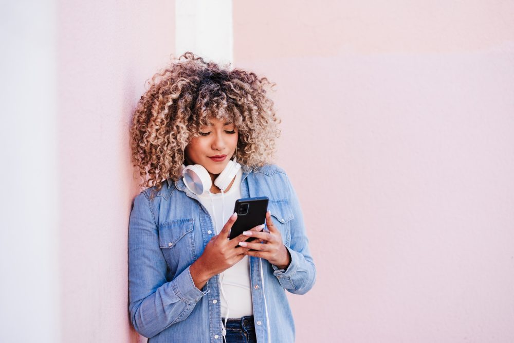 young african american woman looking at her cell phone